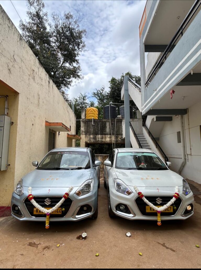 Open trunk of a large taxi, showing ample luggage space for Hubli travel.