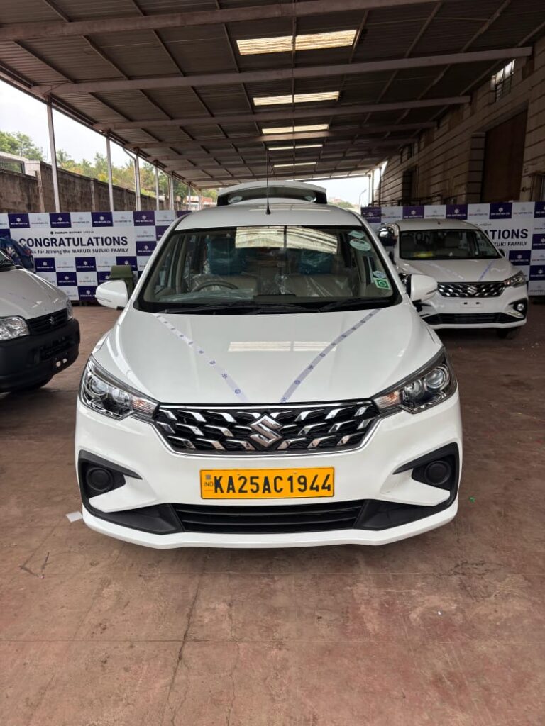 Fleet of clean, modern cars lined up for taxi service in Hubli.